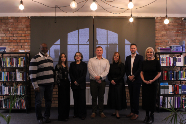 Photo of seven people standing and facing the camera.